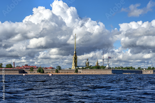 Saint Petersburg city, view of the Peter and Paul fortress from the Neva river. Daytime city landscape, beautiful clouds against the blue sky. photo
