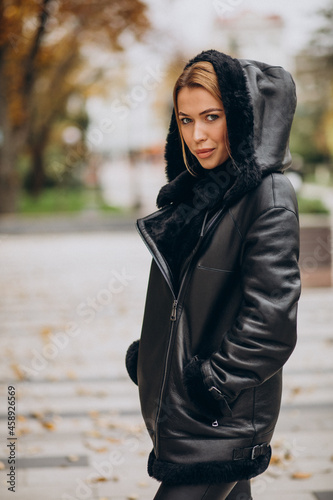 Young woman wearing jacket walking outside