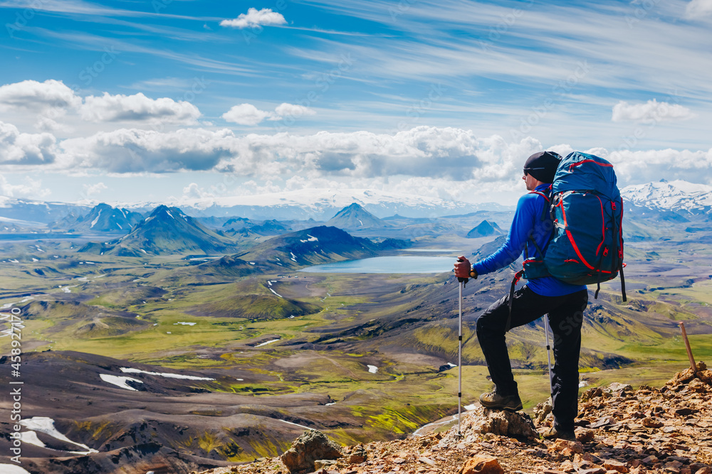 Obraz premium Active hiker enjoying the view on the trail in Landmannalaugar, Iceland. travel, sport, lifestyle concept