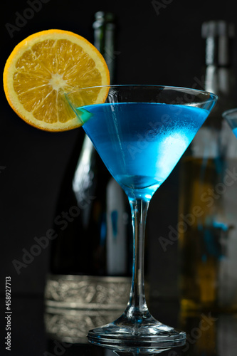 A GLASS OF DINK CURAÇAU BLUE DECORATED WITH ORANGE