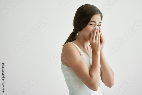 woman with a cold wipes her nose with a handkerchief flu health problems