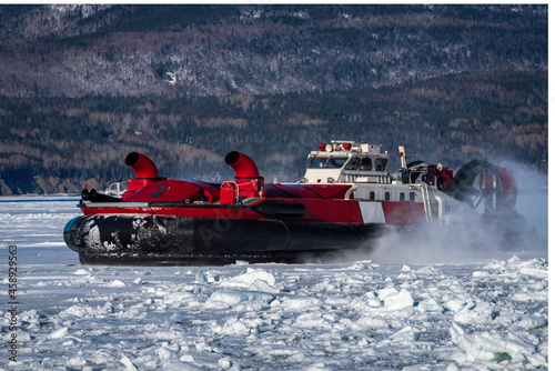 Coast Guard hovercraft breaking ice near a small community in  eastern Quebec, Canada. photo