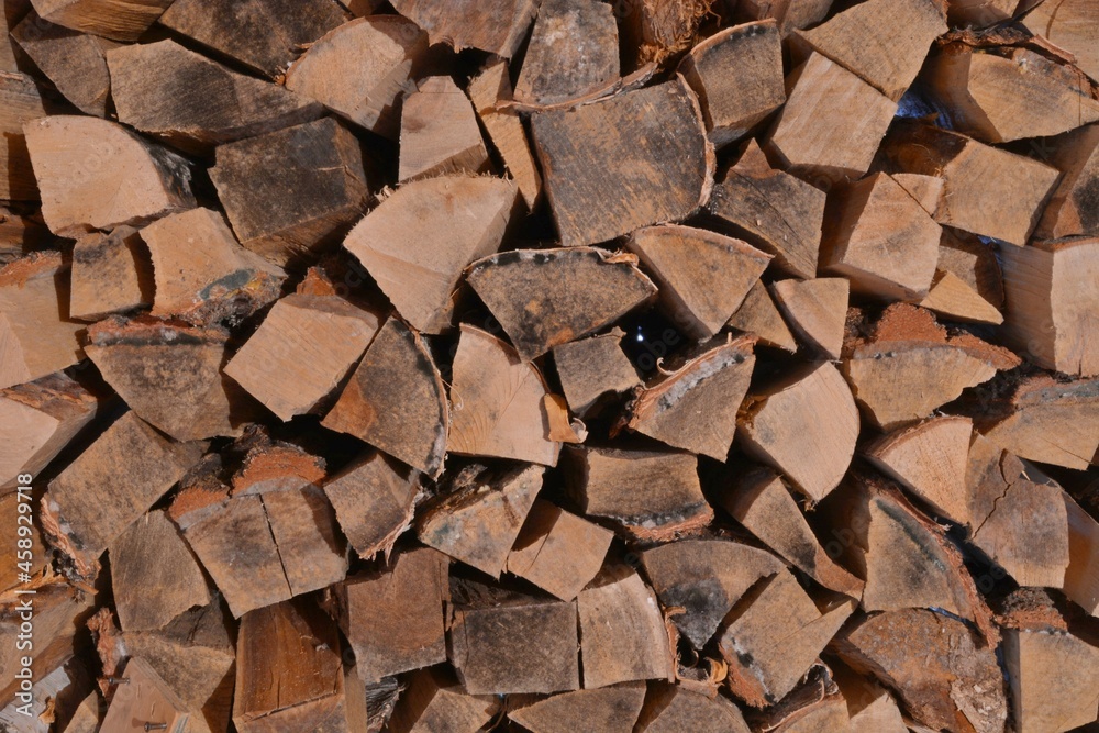 Chopped firewood stacked in a woodpile. Chopped firewood stacked in a woodpile.