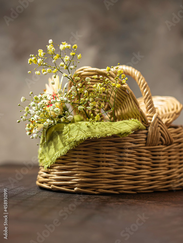 Basket with green napkin picnic on table place. Natural eco materials. Zero west.