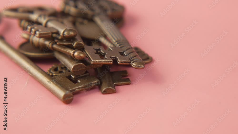 close up of old keys on pink background. close up of old keys on pink background.