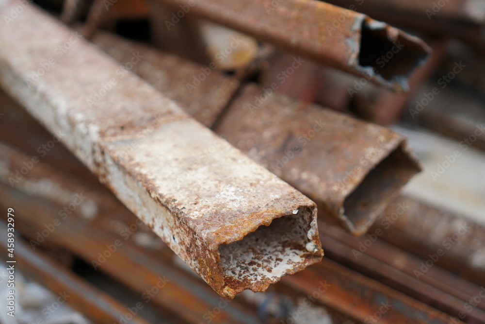 Stack of the old steel tube bars with the rusty, Components in a construction Stack of the old steel tube bars with the rusty, Components in a construction
