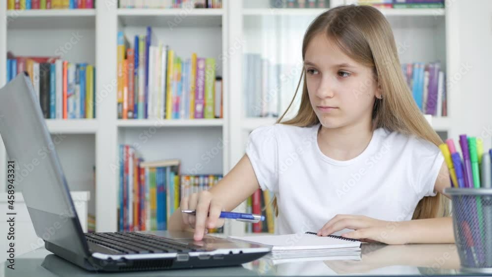 Kid Writing at Laptop in Online Education, Teenager Child Learning, Studying in Coronavirus Pandemic, Girl Doing Working Homework Kid Writing at Laptop in Online Education, Teenager Child Learning, Studying in Coronavirus Pandemic, Girl Doing Working Homework