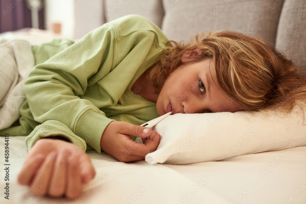 Portrait of sick teen boy measure high temperature Portrait of sick teen boy measure high temperature