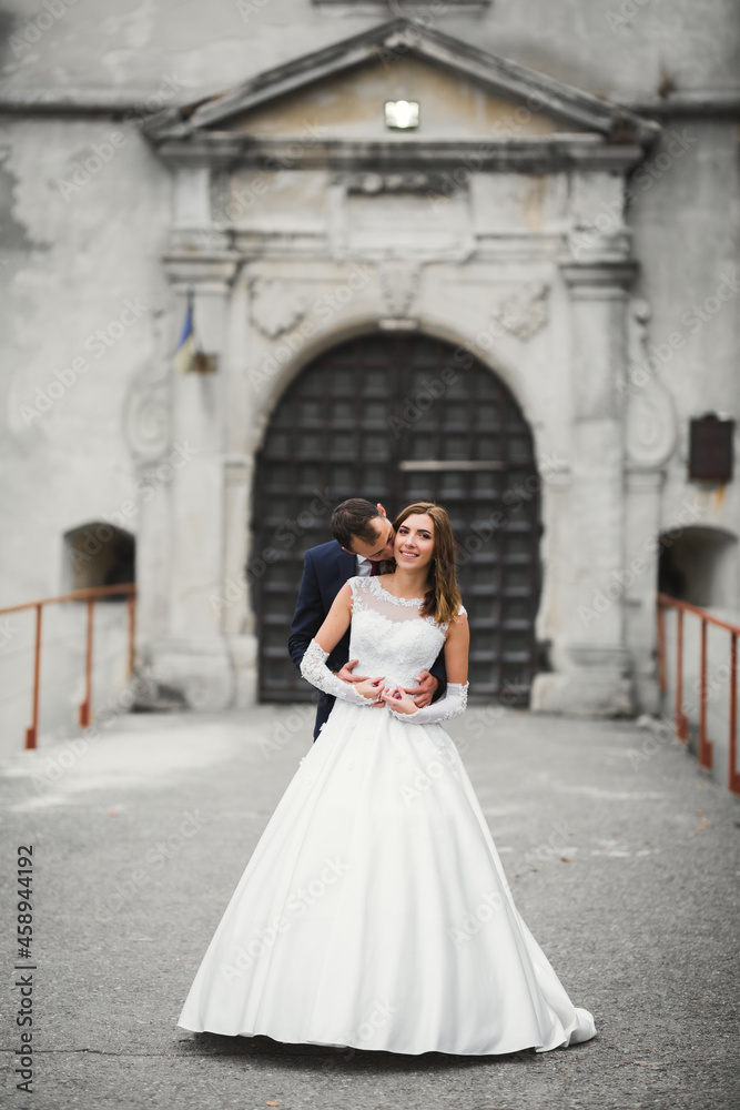 Romantic wedding moment, couple of newlyweds smiling portrait, bride and groom hugging