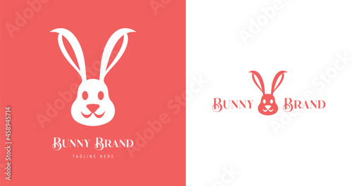 creative bold Minimalist smiling Bunny Head logo for baby care brands and Easter greetings graphic designs