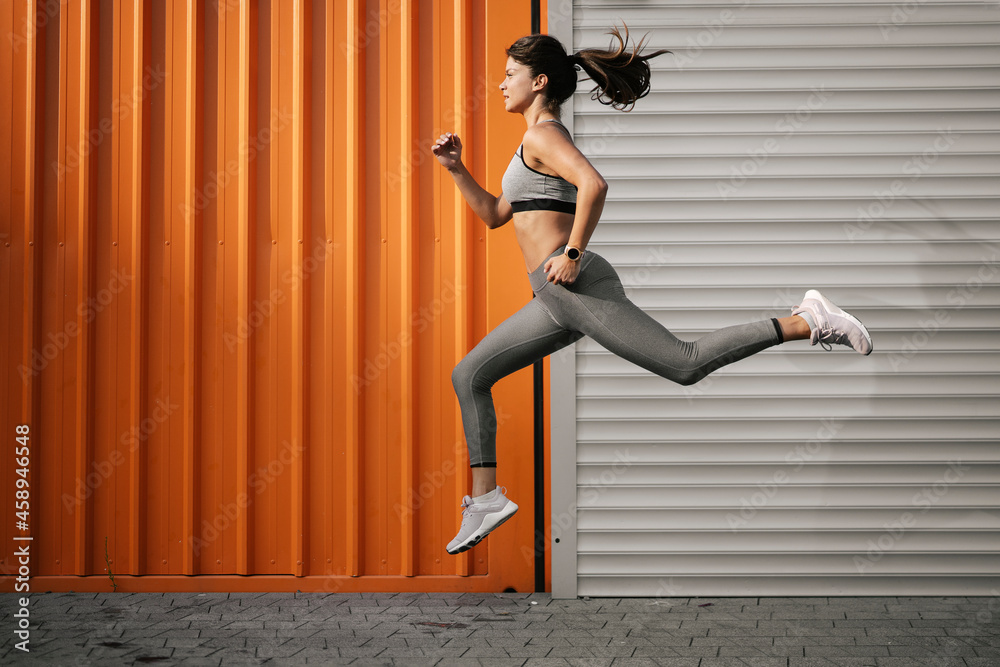 Beautiful athlete woman in sportswear. Young woman training outdoors. Beautiful athlete woman in sportswear. Young woman training outdoors.