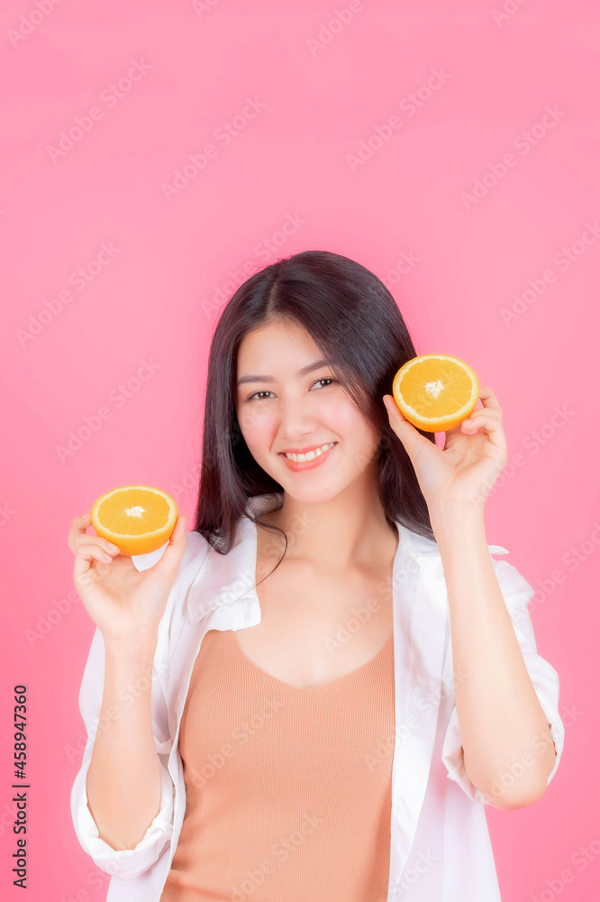 beauty woman Asian cute girl feel happy holding orange fruit for good health on pink background with copy space - lifestyle healthy woman concept beauty woman Asian cute girl feel happy holding orange fruit for good health on pink background with copy space - lifestyle healthy woman concept