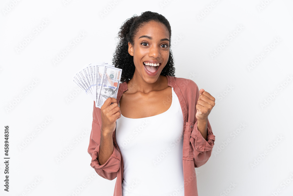 Young African American woman taking a lot of money isolated on white background celebrating a victory in winner position Young African American woman taking a lot of money isolated on white background celebrating a victory in winner position