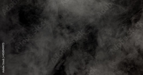 White smoke slowly moving on a black background. photo
