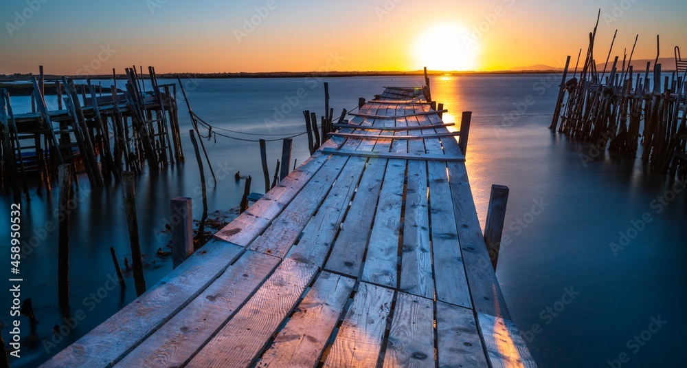 Old fishing pier at sunset in Portugal