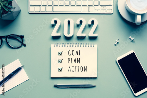 2022 new year goal,plan,action concepts with text on notepad and office accessories.
