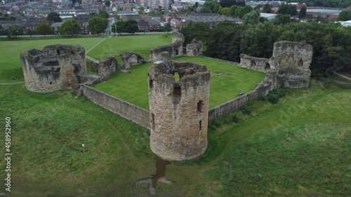 Flint castle Welsh medieval coastal military fortress ruin aerial view left rotating above tower photo