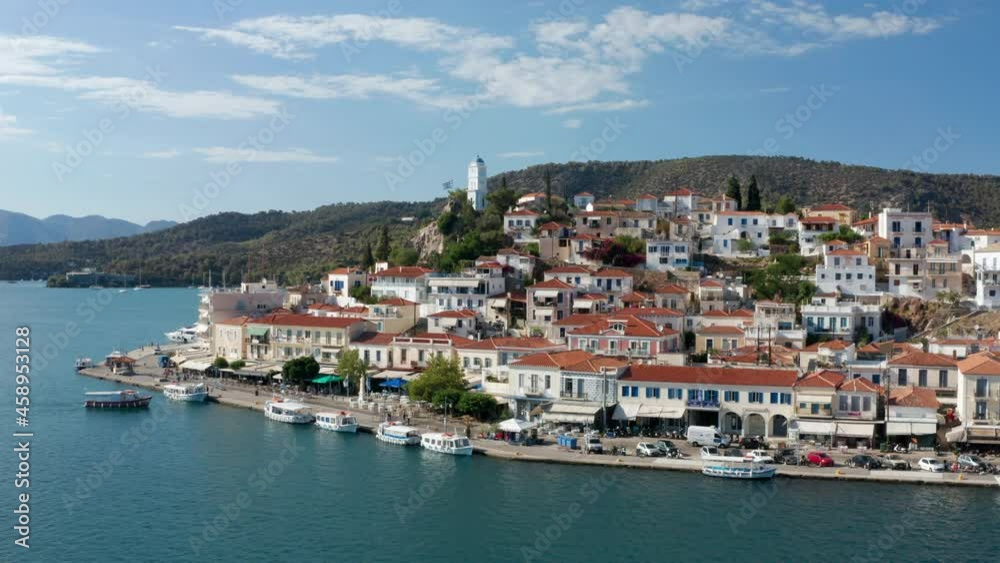 Scenic View Of Buildings And Clock Tower In Poros Island At Summer In Greece, wide aerial Scenic View Of Buildings And Clock Tower In Poros Island At Summer In Greece, wide aerial