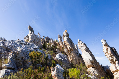 Tall sandstone rock formations on a nature trail.