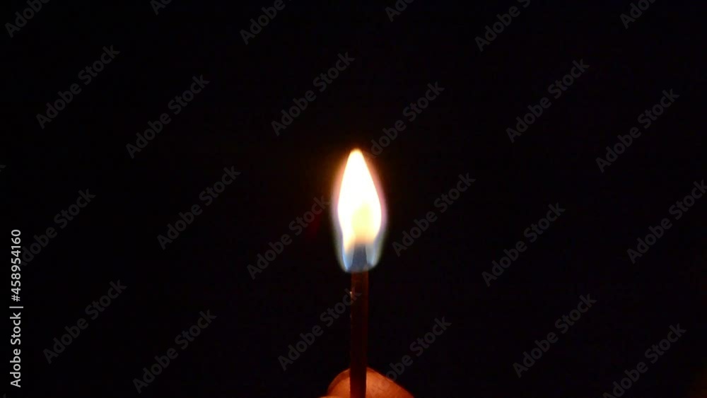 Burning a match. Fire on a black background. Burning a match. Fire on a black background.