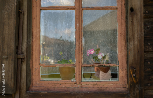 window with flowerpot of old wooden house © avtk