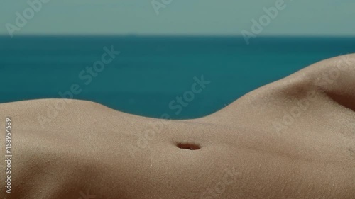  Woman's belly in the sun