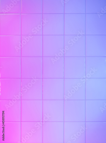 Bathroom tiles wall painted with blue and pink led light
