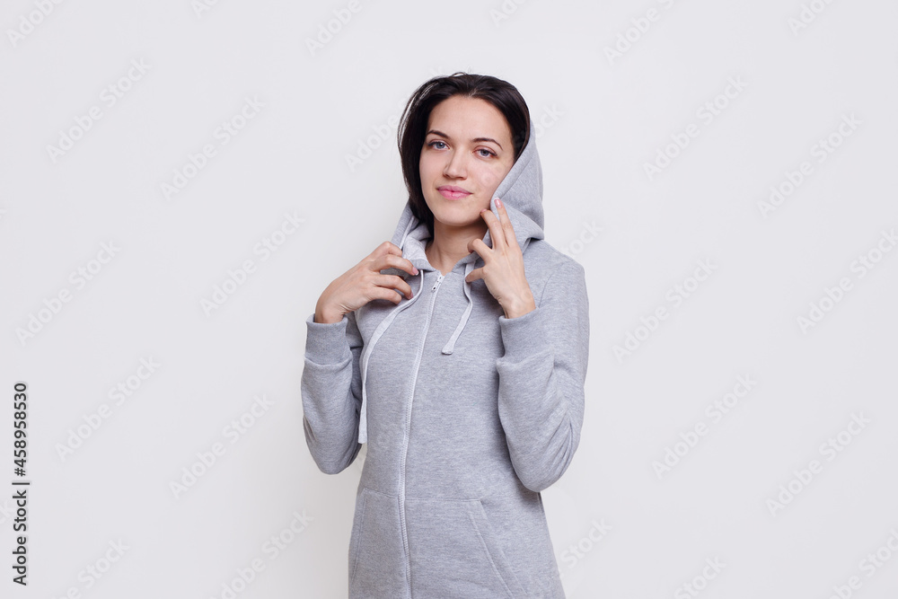 Frontal portrait of a cheerful brunette model dressed in casual clothes, isolated on white background. Frontal portrait of a cheerful brunette model dressed in casual clothes, isolated on white background.