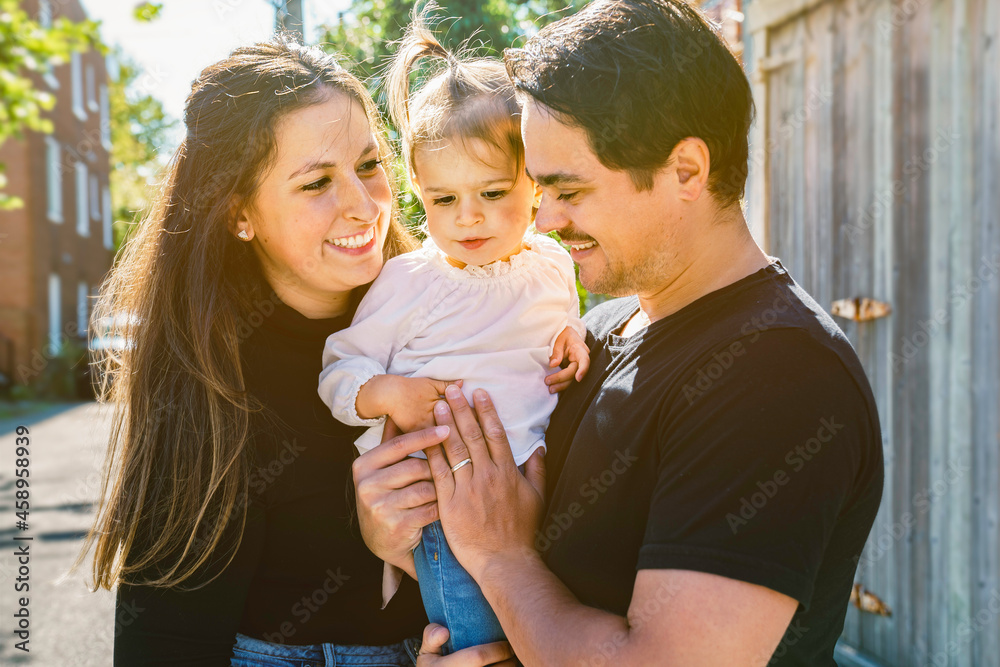 Obraz premium Young family with cute two years old child outside