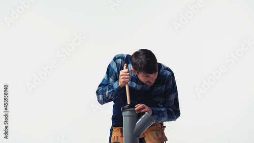 Plumber cleaning plastic pipe with plunger isolated on white