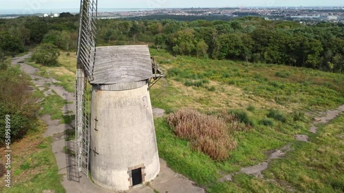 Bidston hill disused rural flour mill restored traditional wooden sail windmill Birkenhead aerial view close left orbit photo