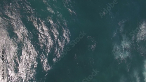 Flying over ocean with big foamy waves