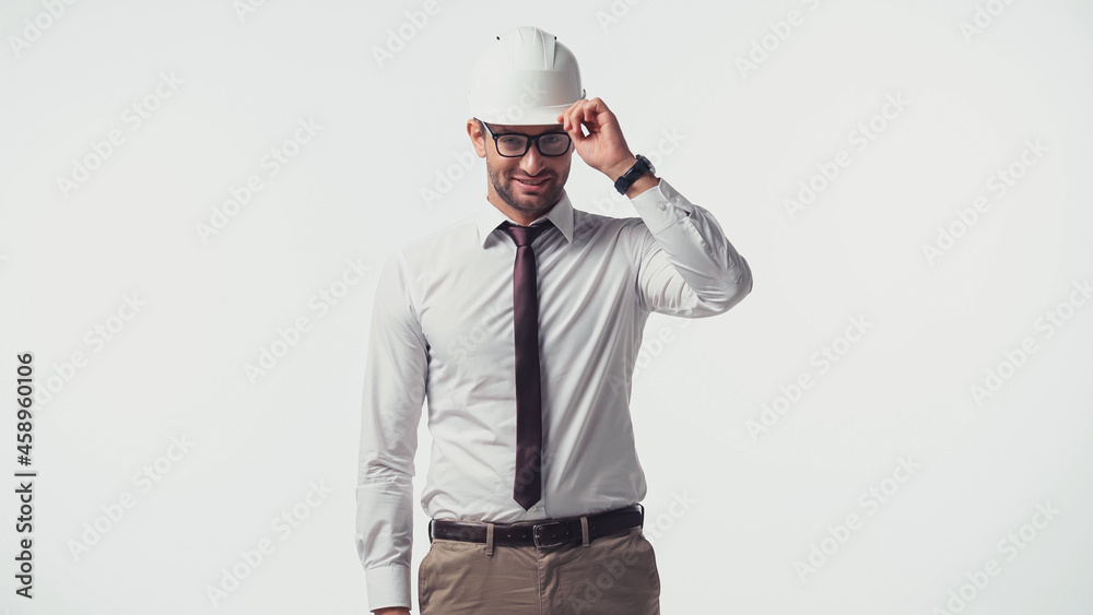 Positive engineer adjusting hardhat isolated on white Positive engineer adjusting hardhat isolated on white