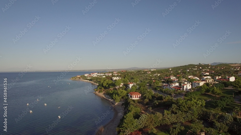 Coastal town scene with blue sea Aerial view of Trikorfo Beach, Greece Coastal town scene with blue sea Aerial view of Trikorfo Beach, Greece
