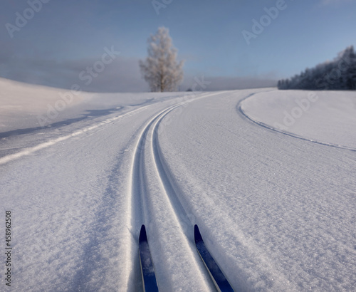 Snowy, hilly cross-country ski track with skiis in Estonia, s-shaped trail in winter. photo