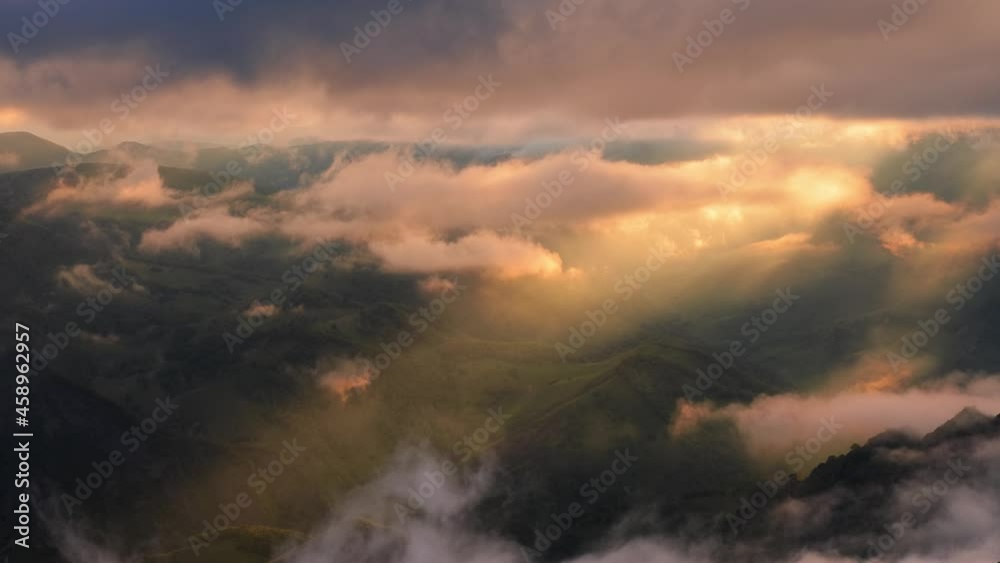Low clouds over a highland plateau in the rays of sunset. Sunset on Bermamyt plateau North Caucasus, Karachay-Cherkessia, Russia. Low clouds over a highland plateau in the rays of sunset. Sunset on Bermamyt plateau North Caucasus, Karachay-Cherkessia, Russia.