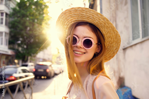 cheerful woman wearing sunglasses outdoors walk summer