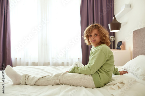 Portrait of sick teen child rest in bed at home