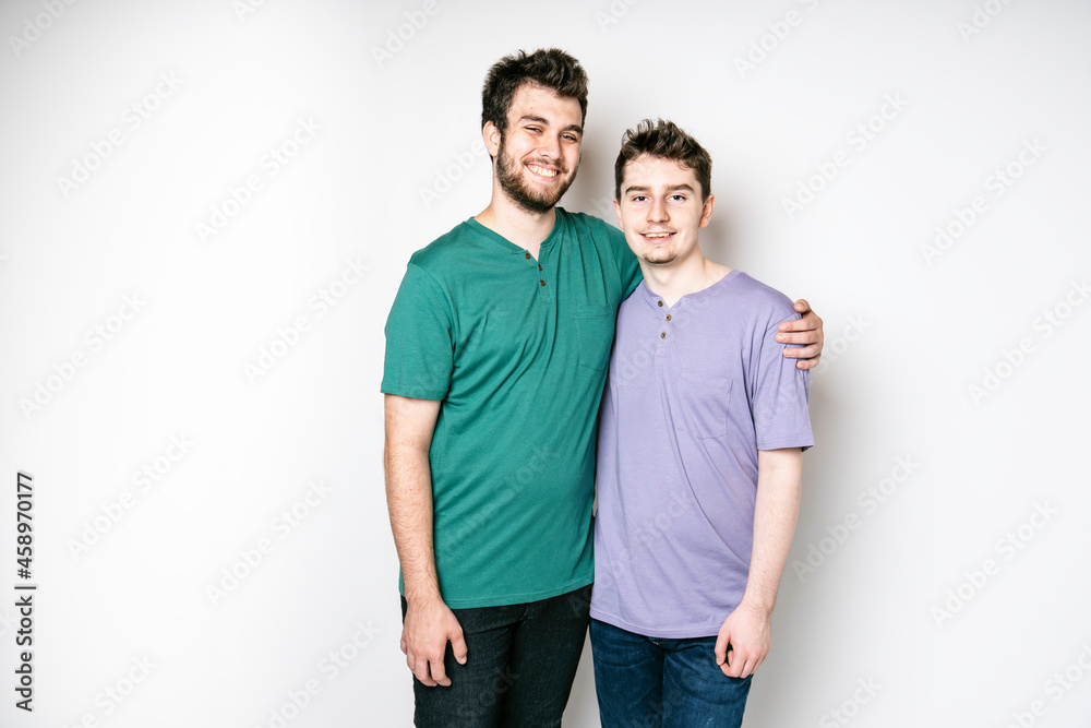 Young gay couple standing together over isolated background Young gay couple standing together over isolated background