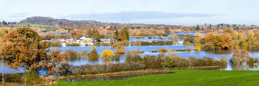 Fototapeta premium A panoramic view of the Yew Tree Inn surrounded by floodwater from the River Severn filling the fields around the Severn Vale village of Chaceley, Gloucestershire UK on 18/11/2019
