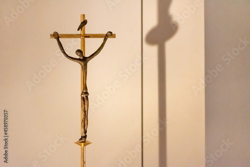 Thin catholic crucifix in gold