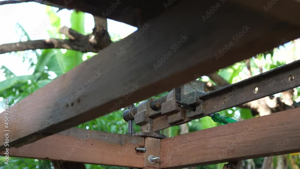 Old metal rusty manual tools, equipment in working place of making timber furniture outdoor in nature background. Concept of wood carpentry, hobby, DIY in free time, vintage retro location Old metal rusty manual tools, equipment in working place of making timber furniture outdoor in nature background. Concept of wood carpentry, hobby, DIY in free time, vintage retro location