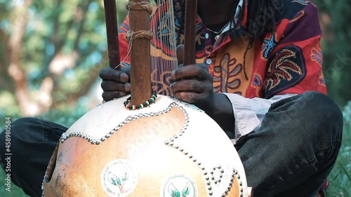 African artist playing an African instrument in a city park