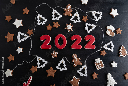 Set of numbers 2022 from ginger biscuits glazed sugar icing. Snowflakes, stars, gingerbread man.
