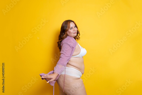 Hispanic plus size young woman in sexy robe and lingerie. Body positivity photo