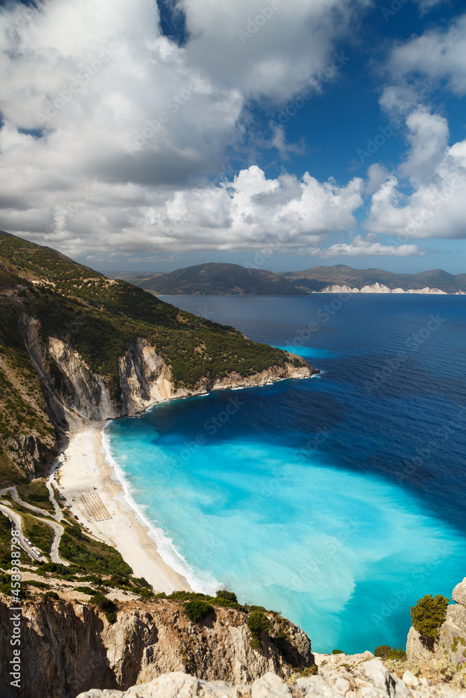 Aerial view at Myrtos Beach and fantastic turquoise and blue Ionian Sea water. Greek islands. Top view, summer scenery of famous and extremely popular travel destination in Cephalonia, Greece, Europe.