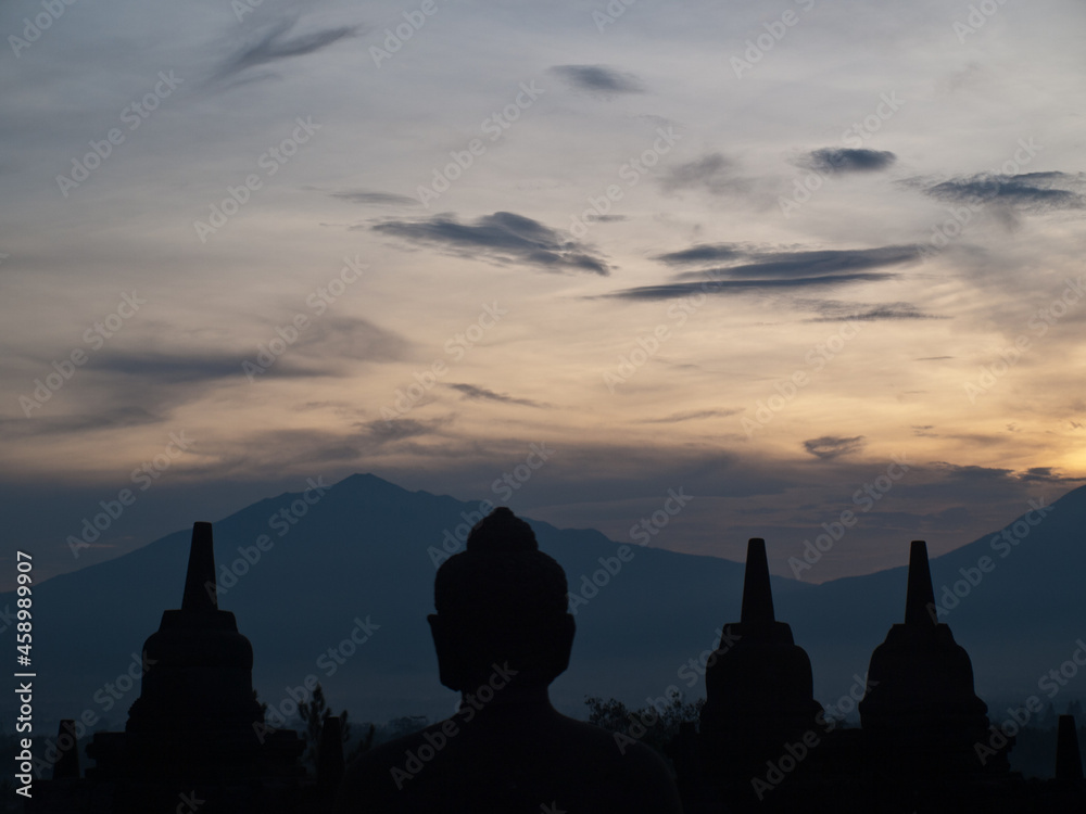 Buddha and stupa silhouettes in the dawn light, Borobudur temple