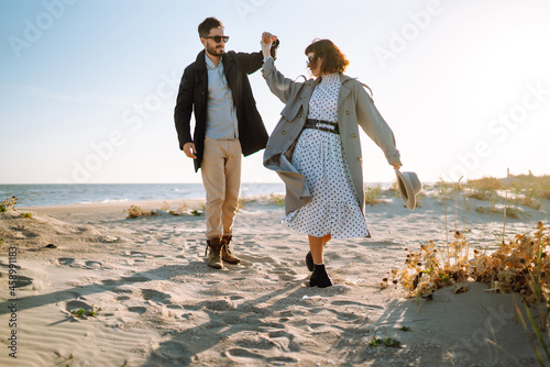 Fotótapéta Fashion couple enjoying each other on beach during autumn sunny day