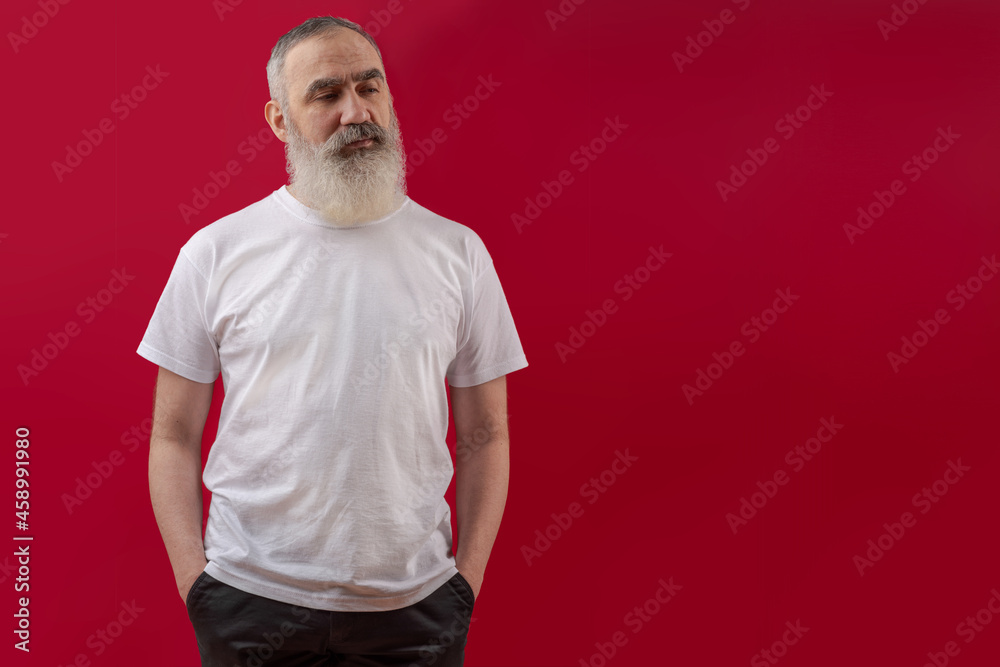 Adult handsome senior male model with a gray beard wearing a white t-shirt. Adult handsome senior male model with a gray beard wearing a white t-shirt.