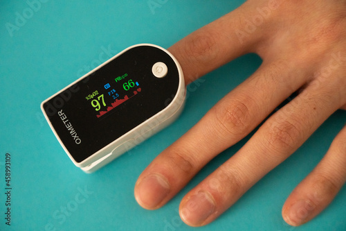 Person measuring their oxygen level using an oximeter.